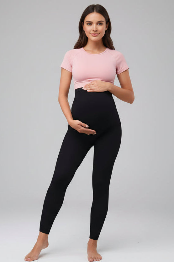 Person wearing black leggings in a home setting