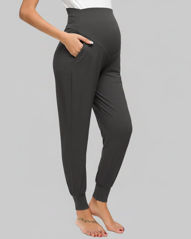 Black leggings worn by a person on a gray background