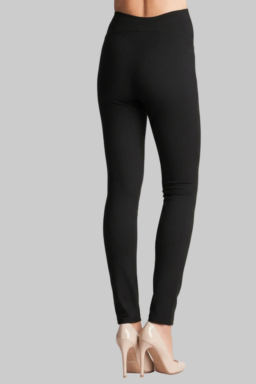 Black leggings worn by a person on a light pink background