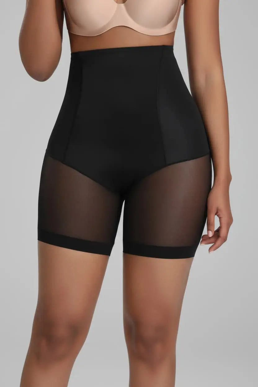 Black sheer shorts worn by a model on a gray background