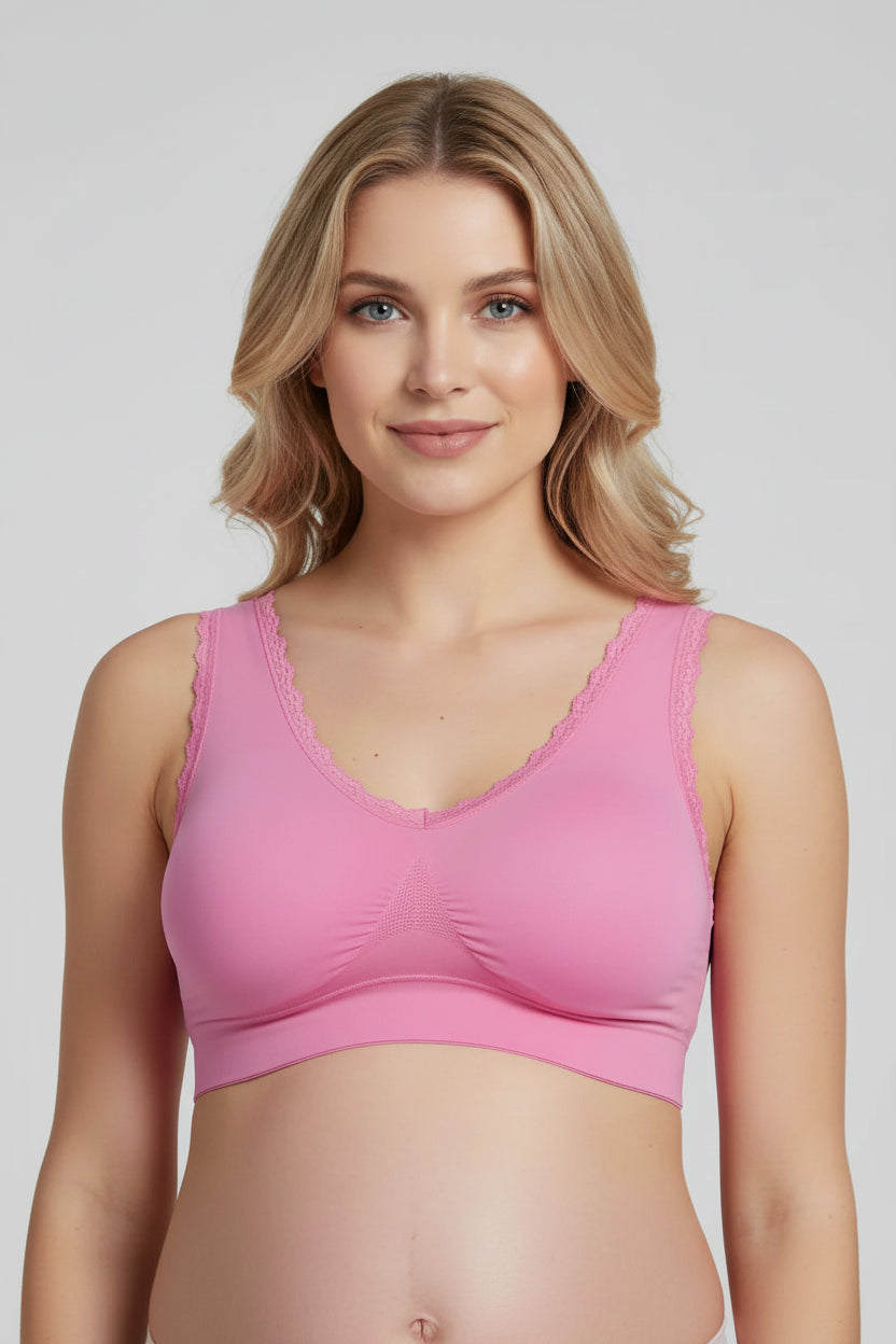 Woman wearing a pink sports bra against a plain background