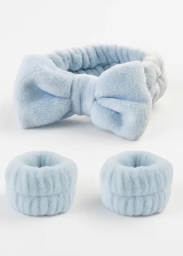 Set of light blue hair accessories including a headband and two bun holders on a white background.
