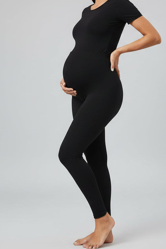 Person wearing black leggings in a home setting