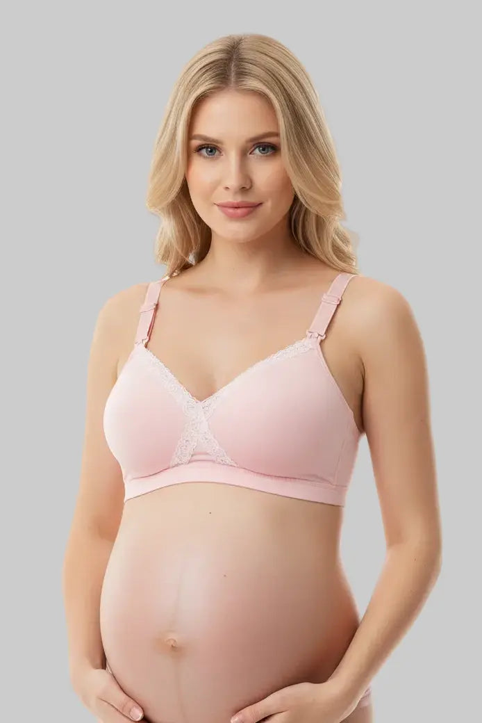 Pregnant woman wearing a pink maternity bra against a gray background