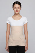Woman wearing a beige compression garment against a gray background