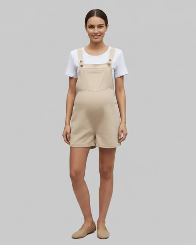 Person wearing beige overalls and a white shirt in a garden setting