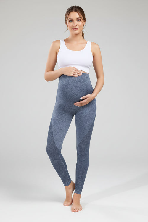 Person wearing blue leggings on a plain background