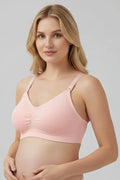 Pregnant woman wearing a pink maternity bra against a gray background